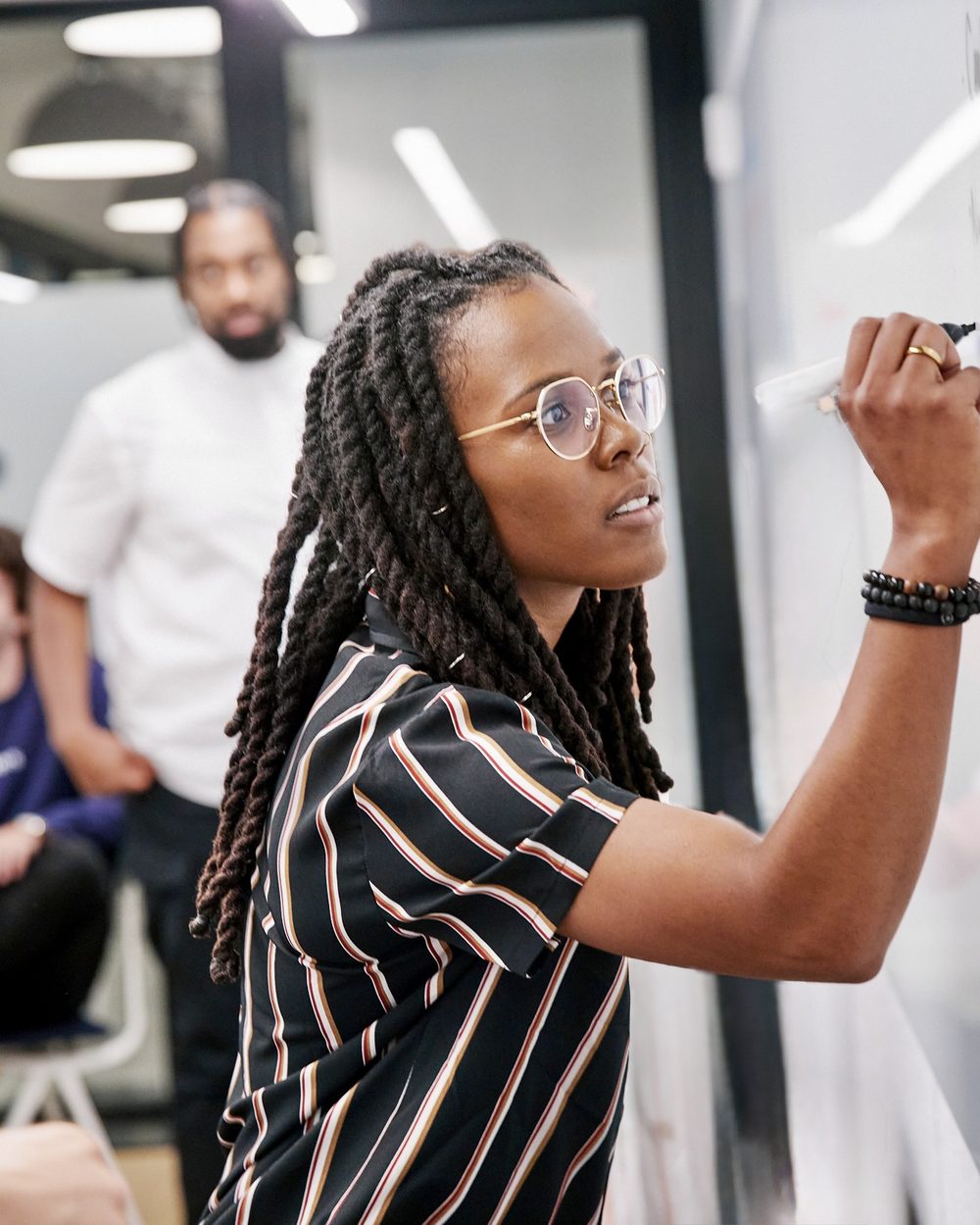 Alexandria Anderson-Dunlop leading a working session at a whiteboard